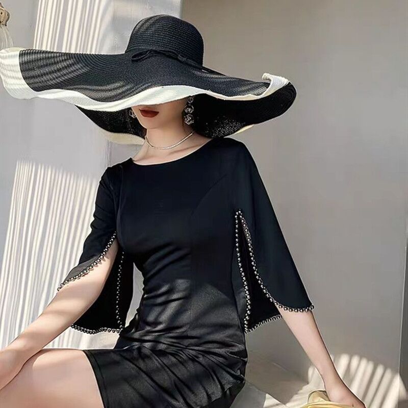 a girl worn black dress with Floppy sun hat